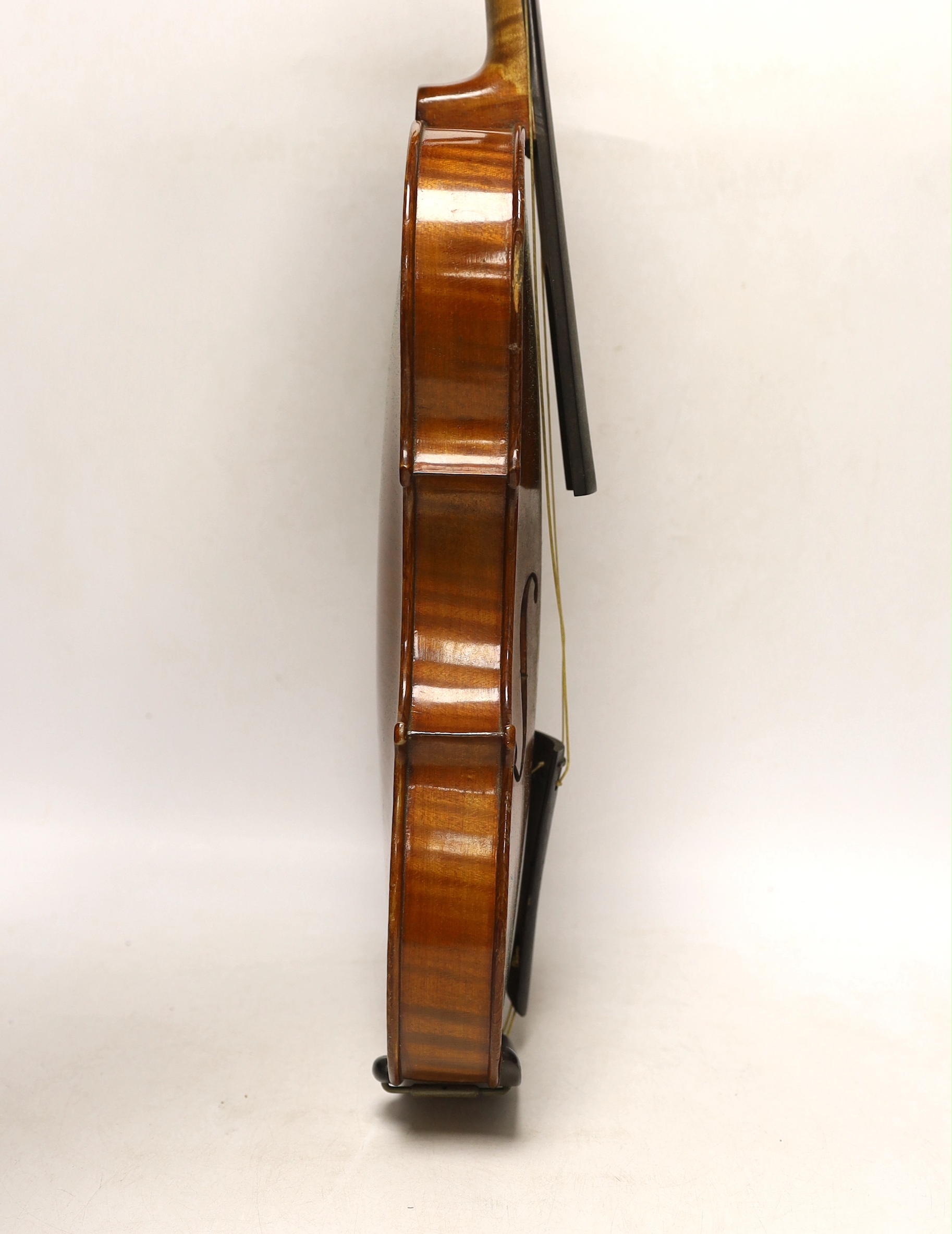 An early 20th century cased violin, length of the back 36cm